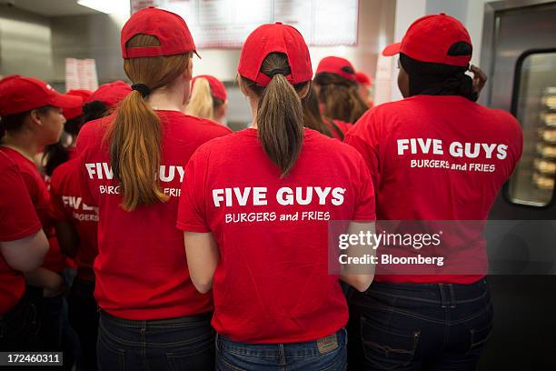 Staff listen during a training session inside the first U.K. Outlet of U.S. Burger restaurant chain Five Guys in London, U.K., on Tuesday, July 2,...