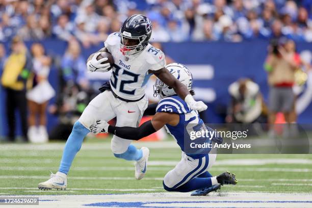 Tyjae Spears of the Tennessee Titans runs the ball against Kenny Moore II of the Indianapolis Colts during the third quarter at Lucas Oil Stadium on...