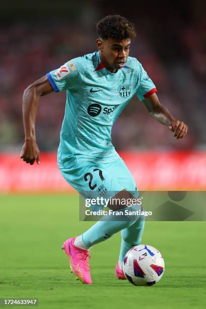 Lamine Yamal of FC Barcelona runs with the ball during the LaLiga EA Sports match between Granada CF and FC Barcelona at Estadio Nuevo Los Carmenes...