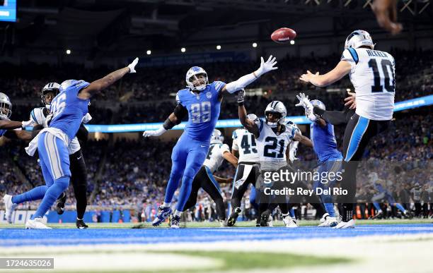 Johnny Hekker of the Carolina Panthers punts the ball while under pressure from Julian Okwara of the Detroit Lions during the third quarter at Ford...