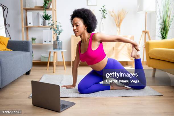 black woman doing yoga exercise - physicist stock pictures, royalty-free photos & images