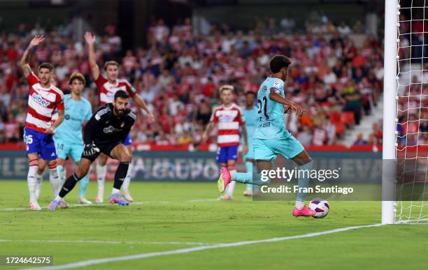 Lamine Yamal of FC Barcelona shoots for score their first side goal during the LaLiga EA Sports match between Granada CF and FC Barcelona at Estadio...