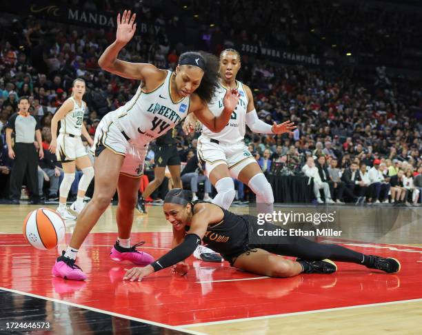 The ball goes out of bounds as A'ja Wilson of the Las Vegas Aces falls to the court trying to catch a pass in front of Betnijah Laney and Kayla...