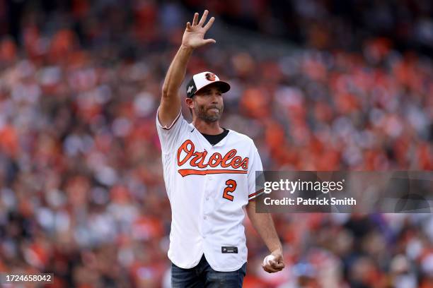 Hardy, a Baltimore Orioles Hall of Fame player, waves to the crowd before throwing the ceremonial first pitch during Game Two of the Division Series...