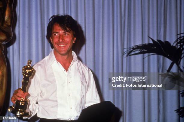 American actor Dustin Hoffman holds up the Oscar statuette he won for Best Actor for his role in the film, 'Kramer vs. Kramer,' Academy Awards,...