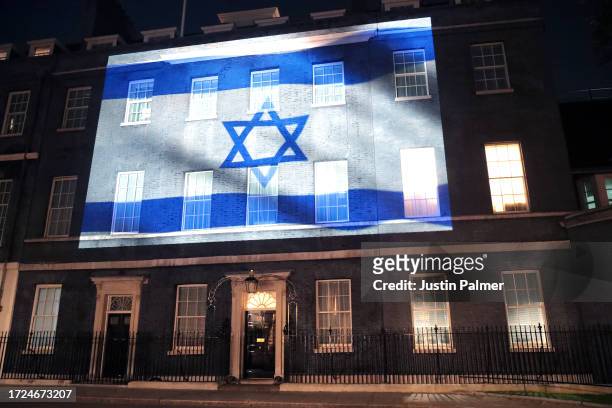 Israel's flag is projected onto the front of 10 Downing Street in a show of support on October 08, 2023 in London, England. After Hamas began rocket...