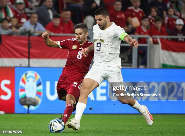 Aleksandar Mitrovic of Serbia in action against Adam Nagy of Hungary during the UEFA EURO 2024 European qualifier match between Hungary and Serbia at...