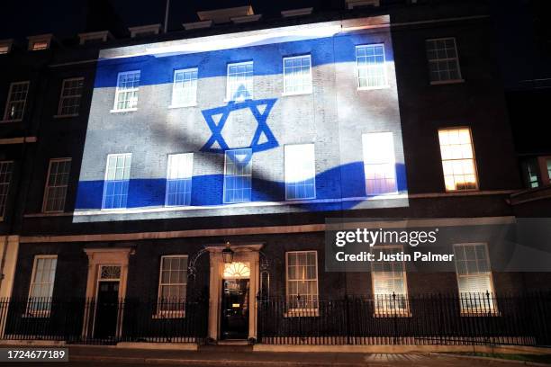 Israel's flag is projected onto the front of 10 Downing Street in a show of support on October 08, 2023 in London, England. After Hamas began rocket...