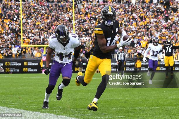George Pickens of the Pittsburgh Steelers runs past Marlon Humphrey of the Baltimore Ravens while scoring a receiving touchdown during the fourth...