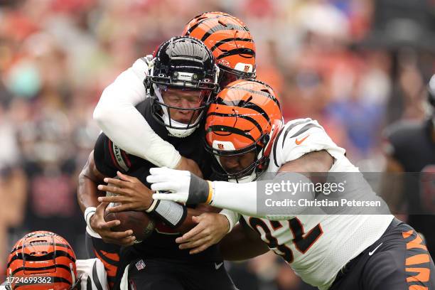 Trey Hendrickson BJ Hill and Sam Hubbard of the Cincinnati Bengals sack Joshua Dobbs of the Arizona Cardinals during the first quarter at State Farm...