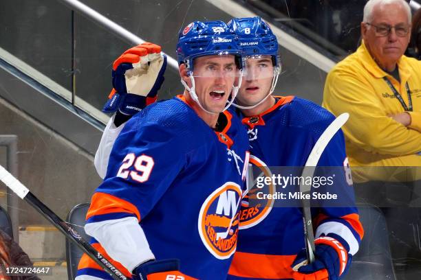 Brock Nelson of the New York Islanders is congratulated by Noah Dobson after scoring a goal against the Buffalo Sabres during the first period at UBS...