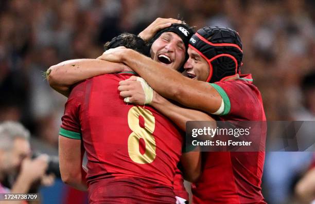 Rafael Simoes, Jose Madeira and Duarte Torgal of Portugal celebrate victory at full-time having secured their first ever World Cup win following the...