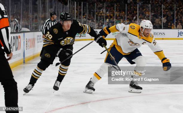 Morgan Geekie of the Boston Bruins checks Roman Josi of the Nashville Predators during the first period at the TD Garden on October 14, 2023 in...