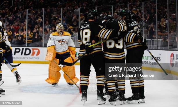 James van Riemsdyk of the Boston Bruins celebrates with teammates Brad Marchand and Pavel Zacha after he scored against Juuse Saros of the Nashville...