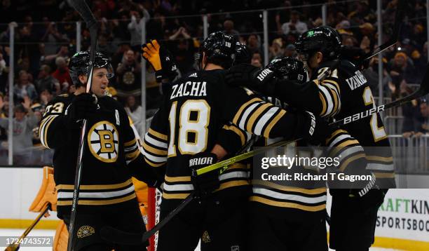 James van Riemsdyk of the Boston Bruins celebrates with teammates Brad Marchand, Charlie McAvoy and Pavel Zacha after he scored against Juuse Saros...