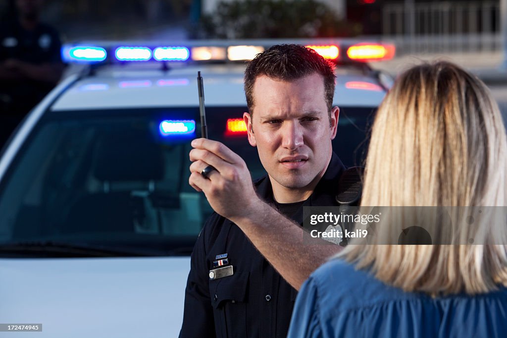 Police officer conducting sobriety test