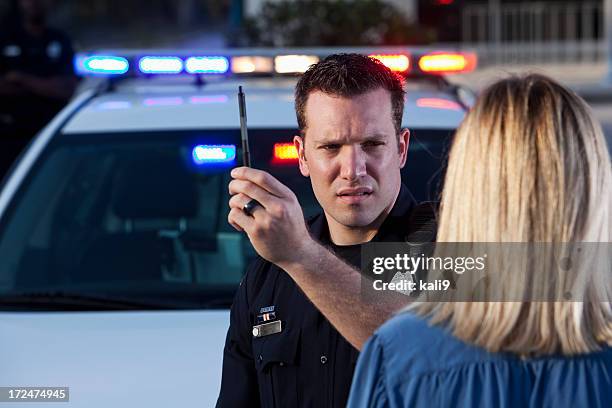 police officer conducting sobriety test - drunk driving stock pictures, royalty-free photos & images