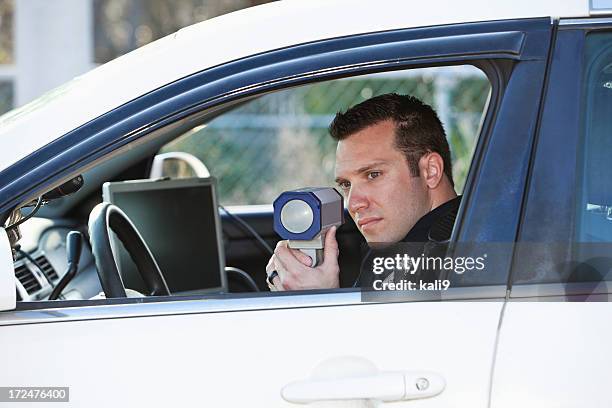 police officer with radar gun - lasergun stockfoto's en -beelden