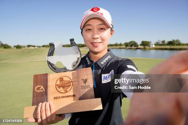 Hyo Joo Kim of South Korea imitates a “selfie” as she poses with the trophy after winning during the final round of The Ascendant LPGA benefiting...