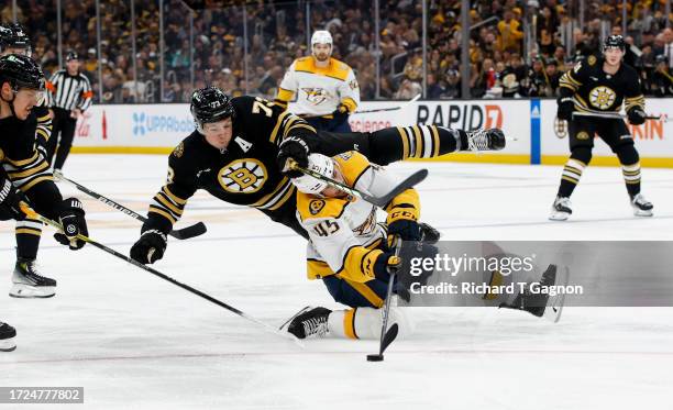 Charlie McAvoy of the Boston Bruins collides with Alexandre Carrier of the Nashville Predators during the second period at the TD Garden on October...