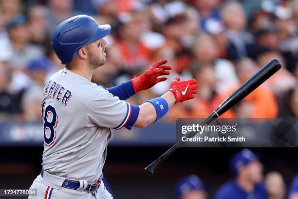 Mitch Garver of the Texas Rangers watches his grand slam against the Baltimore Orioles during the third inning in Game Two of the Division Series at...