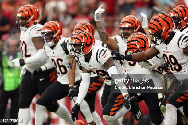 Cam Taylor-Britt of the Cincinnati Bengals celebrates an interception touchdown against the Arizona Cardinals during the second quarter at State Farm...