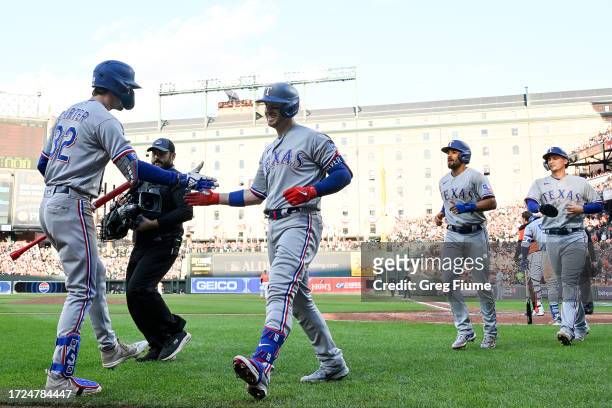 Mitch Garver of the Texas Rangers celebrates his grand slam against the Baltimore Orioles during the third inning in Game Two of the Division Series...
