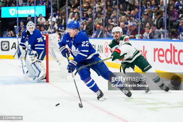 Jake McCabe of the Toronto Maple Leafs plays the puck against Marcus Johansson of the Minnesota Wild during the first period at the Scotiabank Arena...