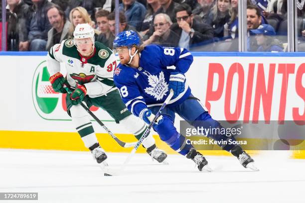 William Nylander of the Toronto Maple Leafs plays the puck against Kirill Kaprizov of the Minnesota Wild during the first period at the Scotiabank...
