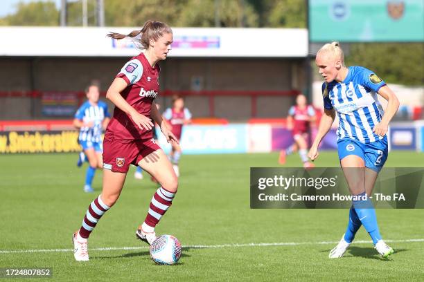 Emma Harries of West Ham United runs with the ball whilst under pressure from Maria Thorisdottir of Brighton & Hove Albion during the Barclays...