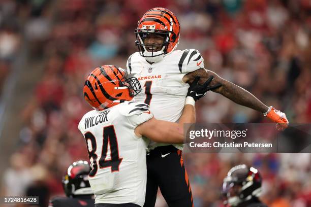 Mitchell Wilcox lifts up Ja'Marr Chase of the Cincinnati Bengals after a touchdown catch against the Arizona Cardinals during the third quarter at...