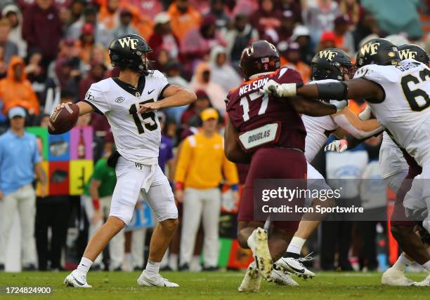 Wake Forest Demon Deacons Quarterback Michael Kern throws a pass from the pocket while being pressured by Virginia Tech Hokies Defensive Lineman Cole...