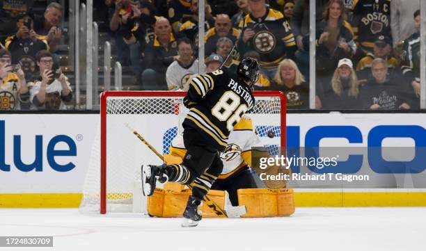 David Pastrnak of the Boston Bruins scores on a penalty shot against Juuse Saros of the Nashville Predators during the second period to take the lead...