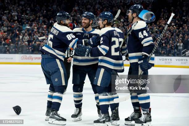 Boone Jenner of the Columbus Blue Jackets is congratulated by his teammates after scoring his third goal of the game for the hat trick during the...
