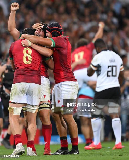 Rafael Simoes, Jose Madeira and Duarte Torgal of Portugal celebrate victory at full-time having secured their first ever World Cup win following the...