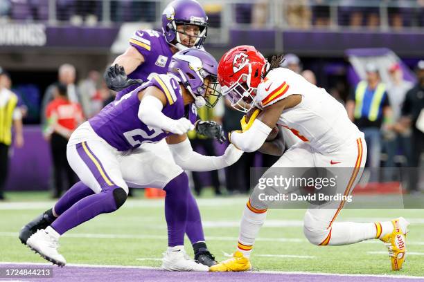 Camryn Bynum of the Minnesota Vikings attempts to tackle Rashee Rice of the Kansas City Chiefs while Rice scores a receiving touchdown during the...