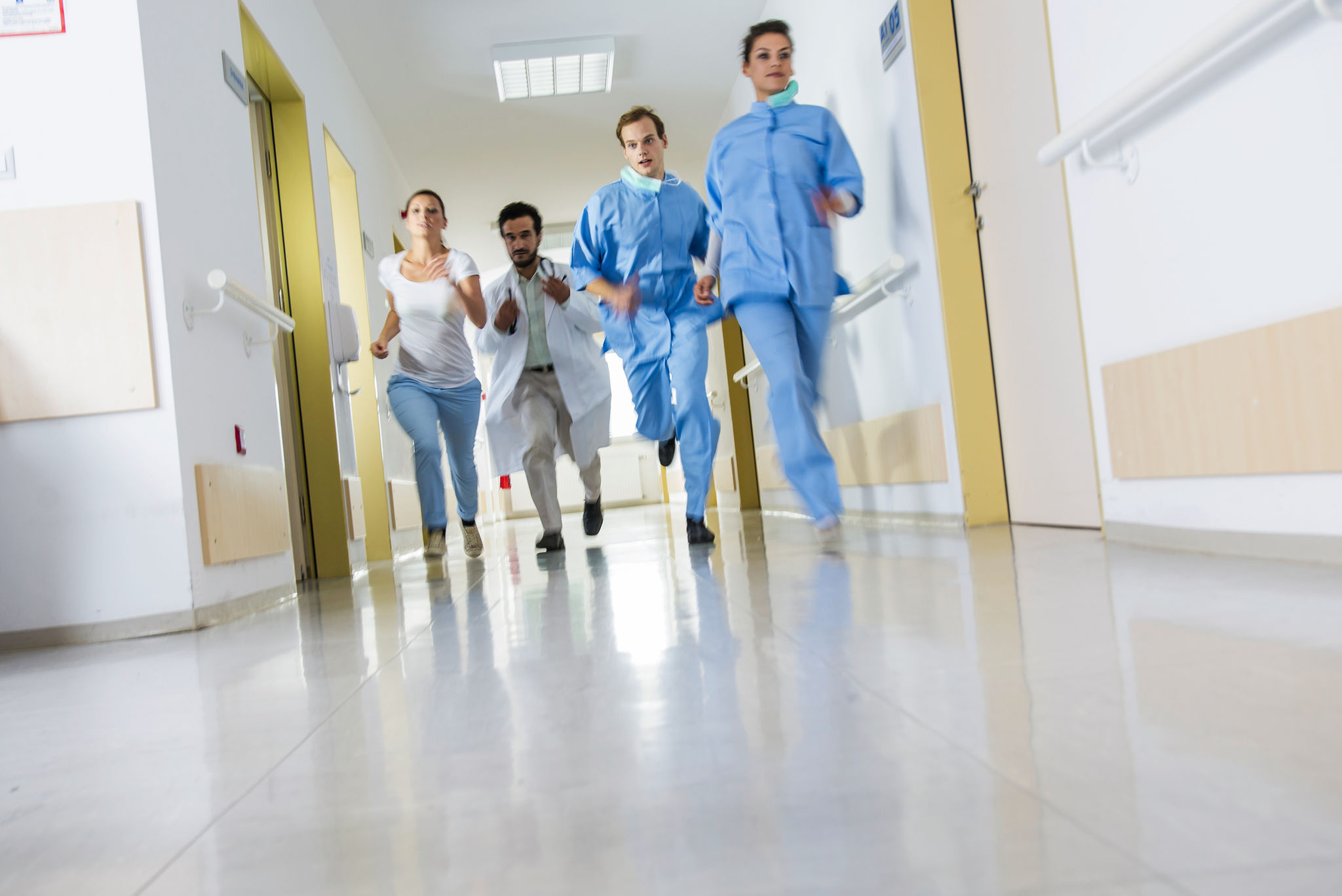 Doctors and nurses rushes for emergency in hospital corridor Doctors and nurses rushes for emergency in hospital corridor