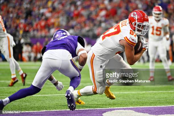 Travis Kelce of the Kansas City Chiefs runs past Byron Murphy Jr. #7 of the Minnesota Vikings while scoring a receiving touchdown during the third...