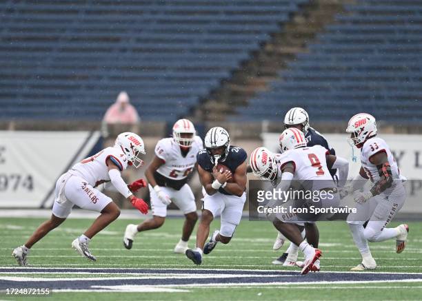 Yale Bulldogs running back Spencer Alston secures the ball while the Sacred Heart Pioneersdefense close in on the play during the game as the Sacred...