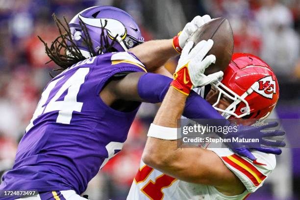 Travis Kelce of the Kansas City Chiefs catches a pass while Josh Metellus of the Minnesota Vikings defends during the third quarter at U.S. Bank...