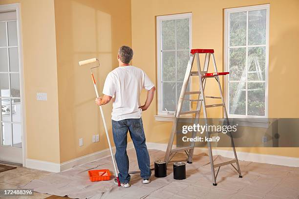 man painting home interior - looking at a painting stock pictures, royalty-free photos & images