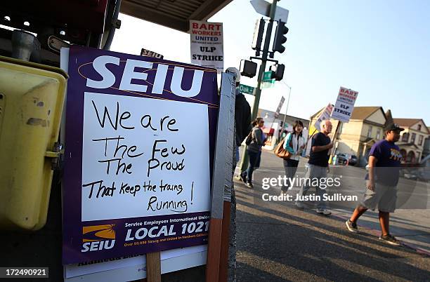 Bay Area Rapid Transit union workers with SEIU Local 1021 hold signs as they picket in front of the Lake Merritt station on July 2, 2013 in Oakland,...