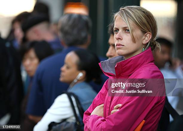 Commuters wait in line for an Alameda-Contra Costa Transit bus to arrive on July 2, 2013 in Oakland, California. For a second day, hundreds of...