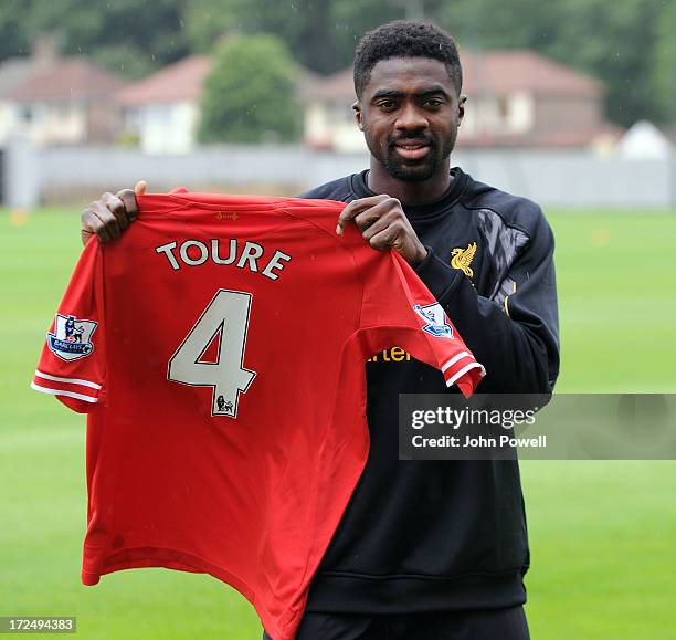 Kolo Toure of Liverpool signs a contract for Liverpool Football Club at Melwood Training Ground on July 2, 2013 in Liverpool, England.