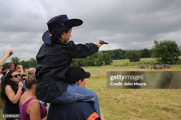 Zackary Howey from Warren, Michigan, dressed in Union attire, "fires" on Confederate Civil War re-enactors on the 150th anniversary of the historic...