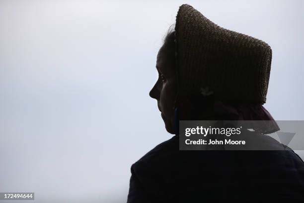 Woman dressed in southern Civil War era attire watches a Confederate re-enactment on the 150th anniversary of the historic Battle of Gettysburg on...