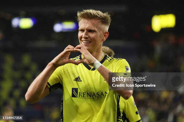 Nashville SC forward Sam Surridge makes a heart sign to the crowd after scoring a goal during a match between Nashville SC and New England...