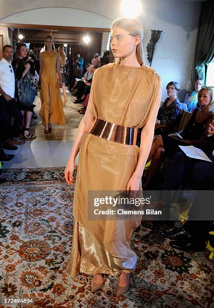 Model walks the runway at the Green Showroom during Mercedes-Benz Fashion Week Spring/Summer 2014 at Brandenburg Gate on July 2, 2013 in Berlin,...