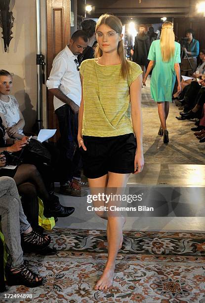 Model walks the runway at the Green Showroom during Mercedes-Benz Fashion Week Spring/Summer 2014 at Brandenburg Gate on July 2, 2013 in Berlin,...