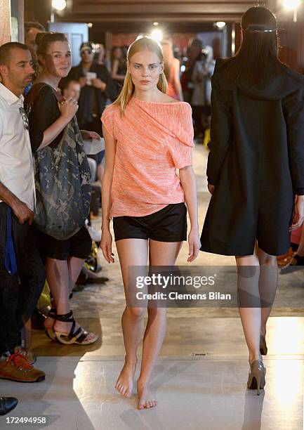 Models walk the runway at the Green Showroom during Mercedes-Benz Fashion Week Spring/Summer 2014 at Brandenburg Gate on July 2, 2013 in Berlin,...